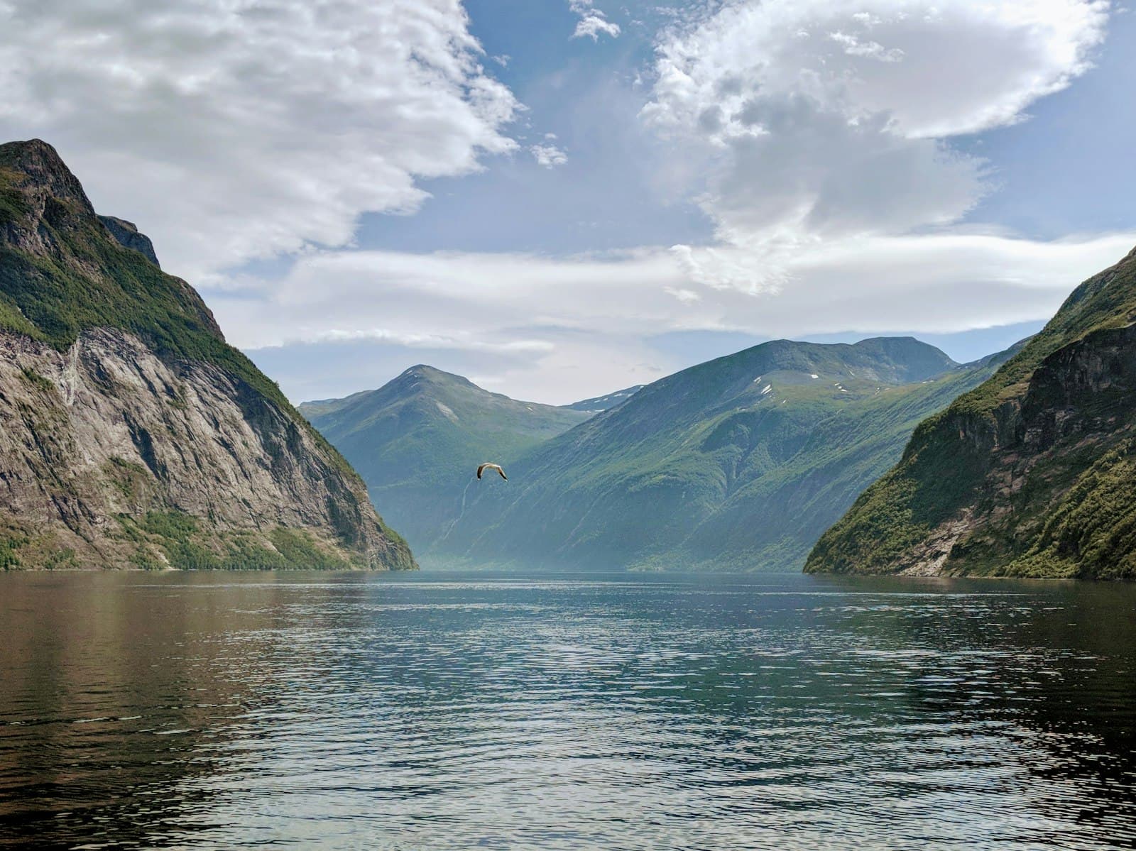 A dramatic fjord and mountain peak under storm light, the high fortress of the Aesir
